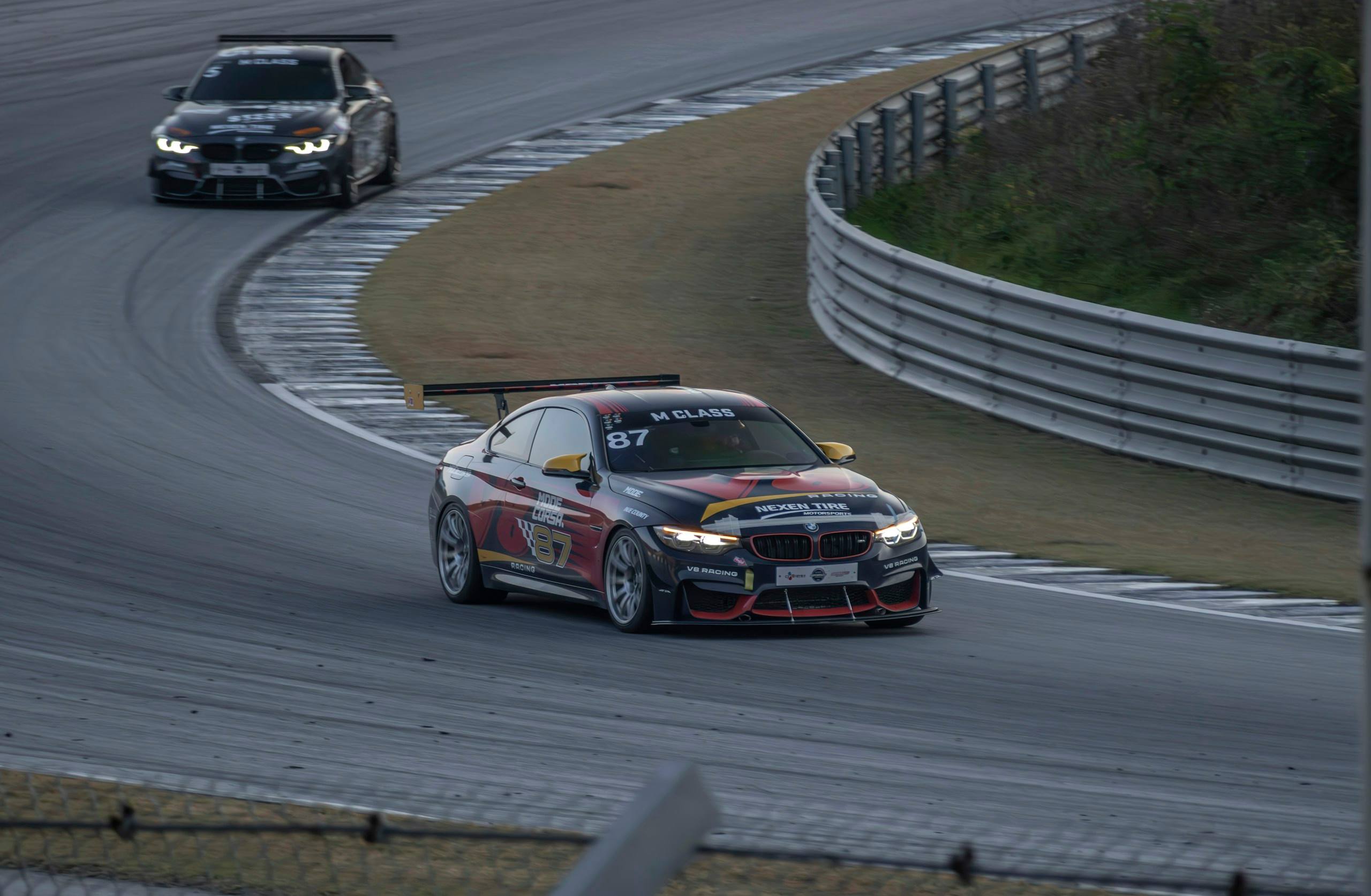 Two cars on track, one behind the other